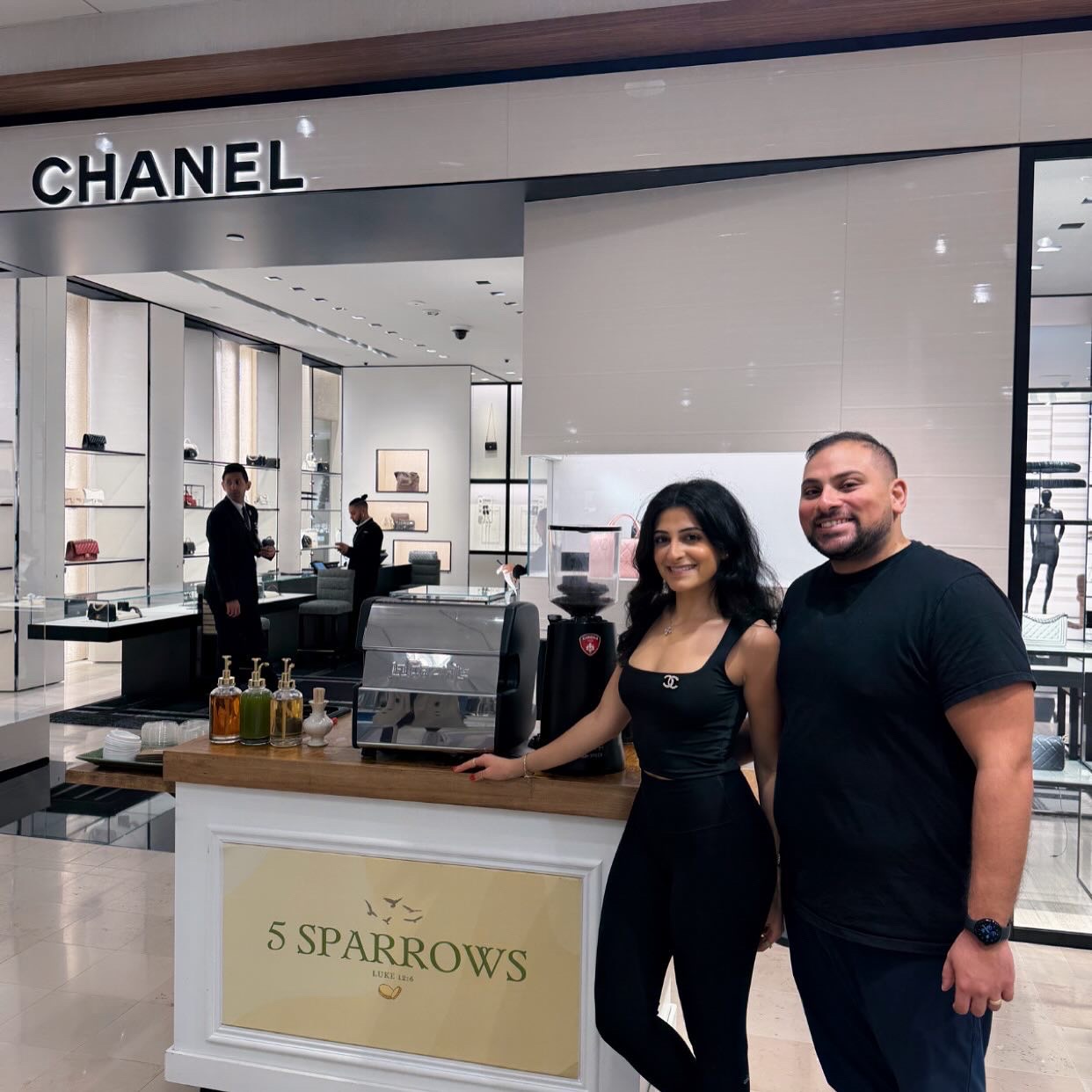 The husband-and-wife founders behind 5 Sparrows next to their cart and Zenith espresso machine